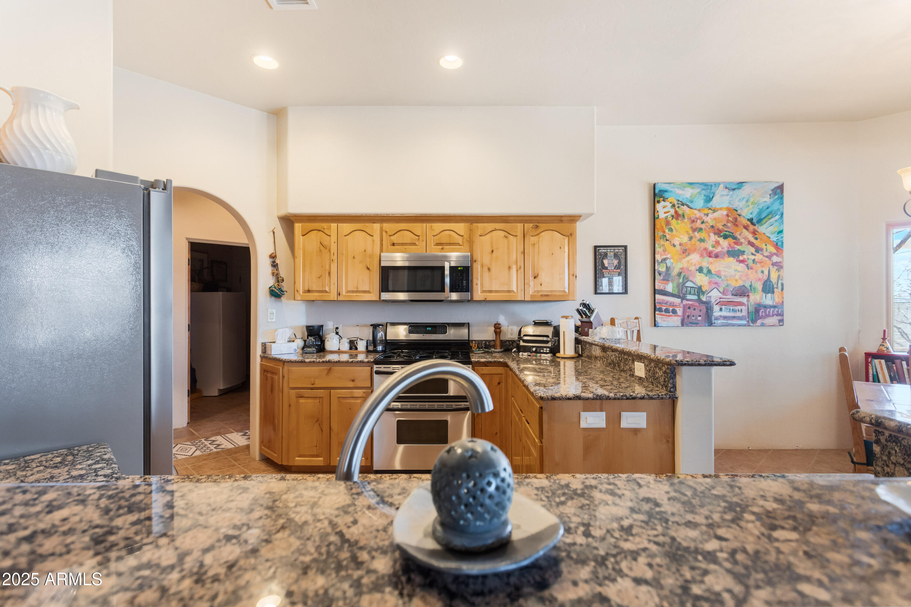 8765 South Airstrip Road Hereford, AZ 85615 - Photo 13 of 47 a kitchen with stainless steel appliances granite countertop a sink and a refrigerator