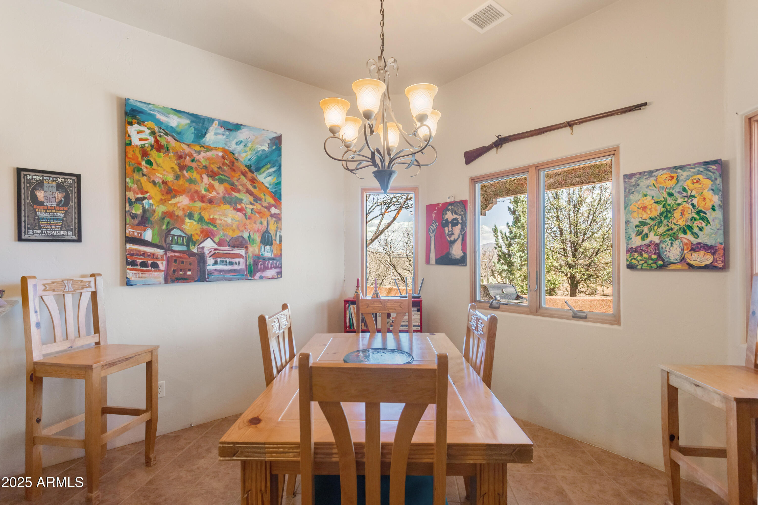 8765 South Airstrip Road Hereford, AZ 85615 - Photo 14 of 47 a view of a dining room with furniture a chandelier and wooden floor