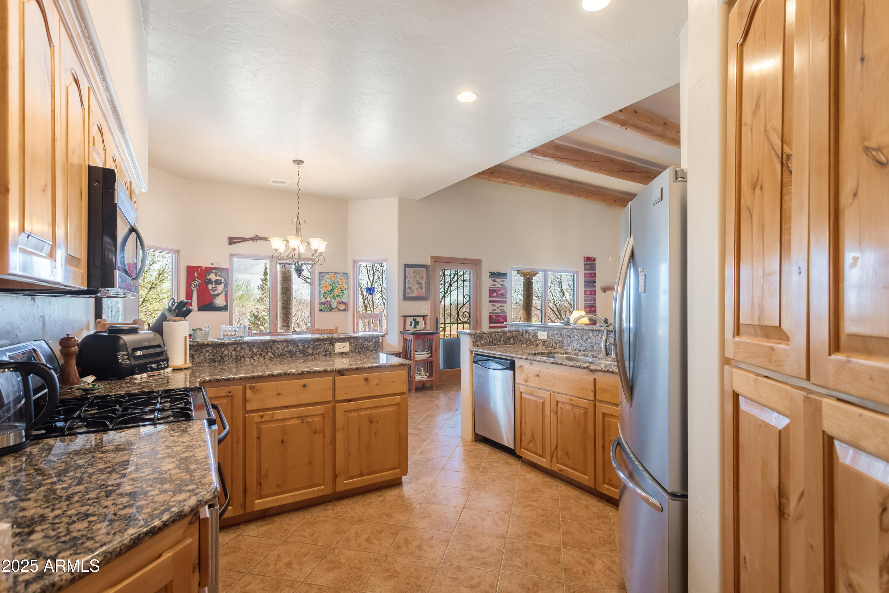 8765 South Airstrip Road Hereford, AZ 85615 - Photo 16 of 47 a kitchen with cabinets and wooden floor