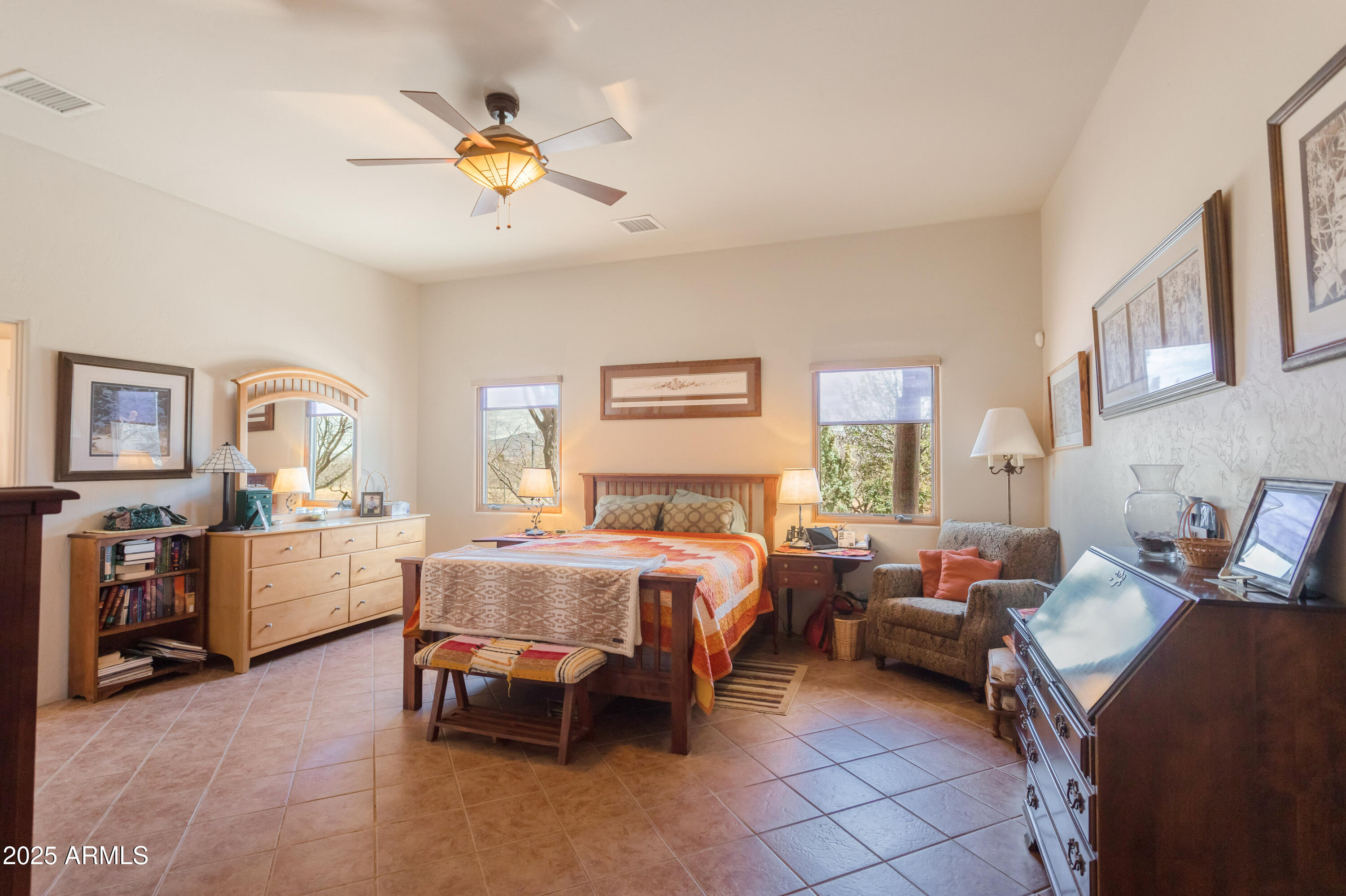 8765 South Airstrip Road Hereford, AZ 85615 - Photo 17 of 47 a bed room with furniture and a chandelier