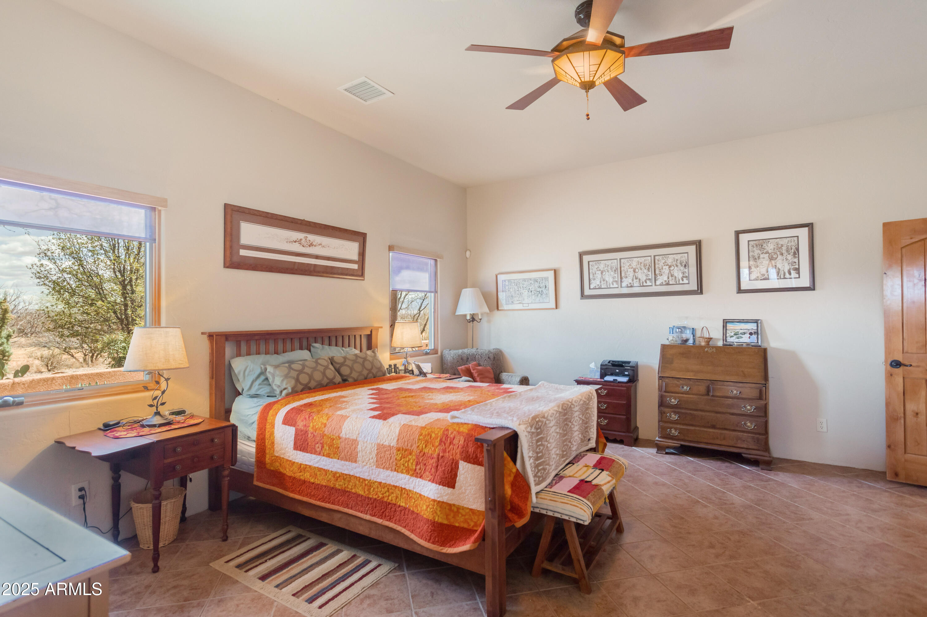 8765 South Airstrip Road Hereford, AZ 85615 - Photo 18 of 47 a bedroom with a bed and a chandelier
