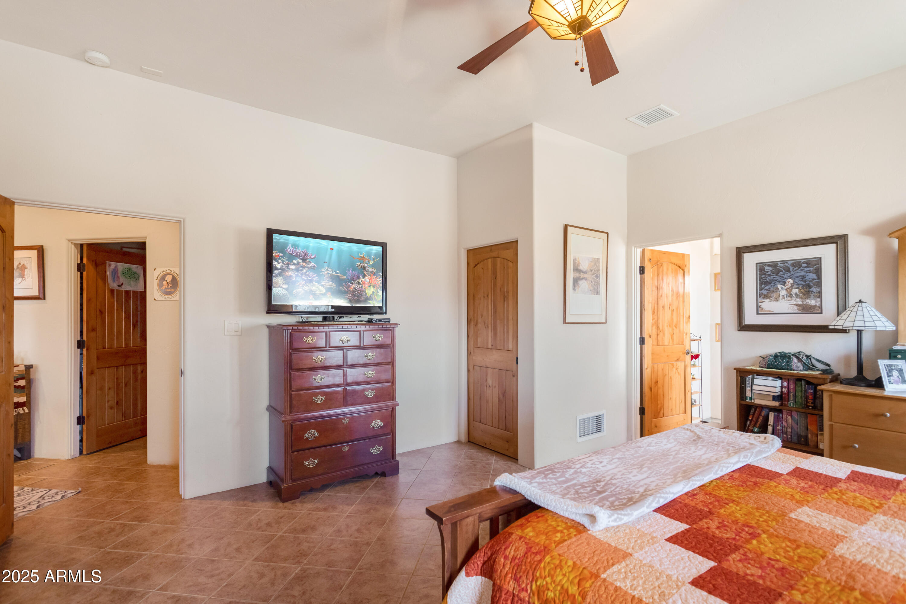 8765 South Airstrip Road Hereford, AZ 85615 - Photo 19 of 47 a bed room with a bed and a chandelier
