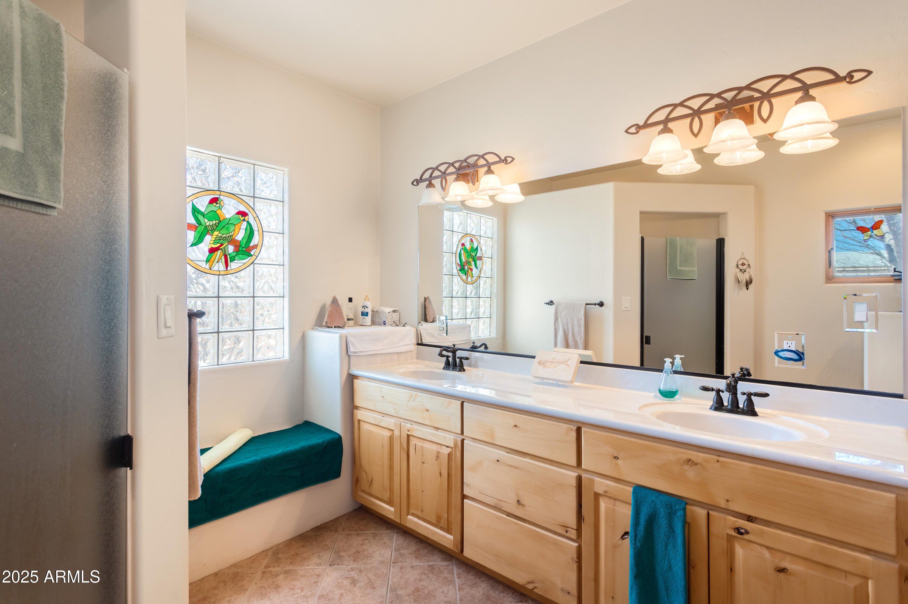 8765 South Airstrip Road Hereford, AZ 85615 - Photo 20 of 47 a spacious bathroom with a double vanity sink mirror and next to a window