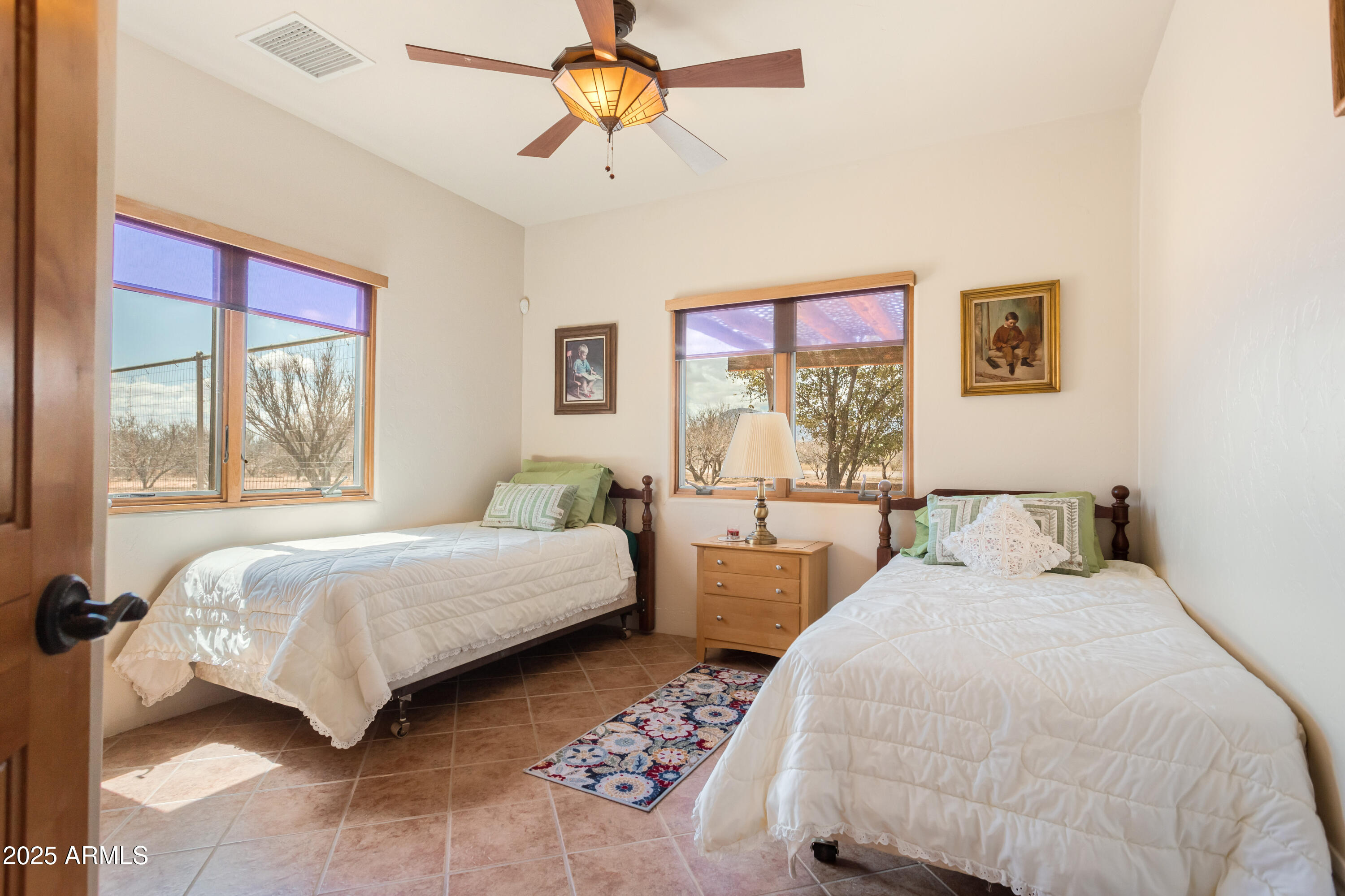 8765 South Airstrip Road Hereford, AZ 85615 - Photo 22 of 47 a bedroom with two beds and a chandelier