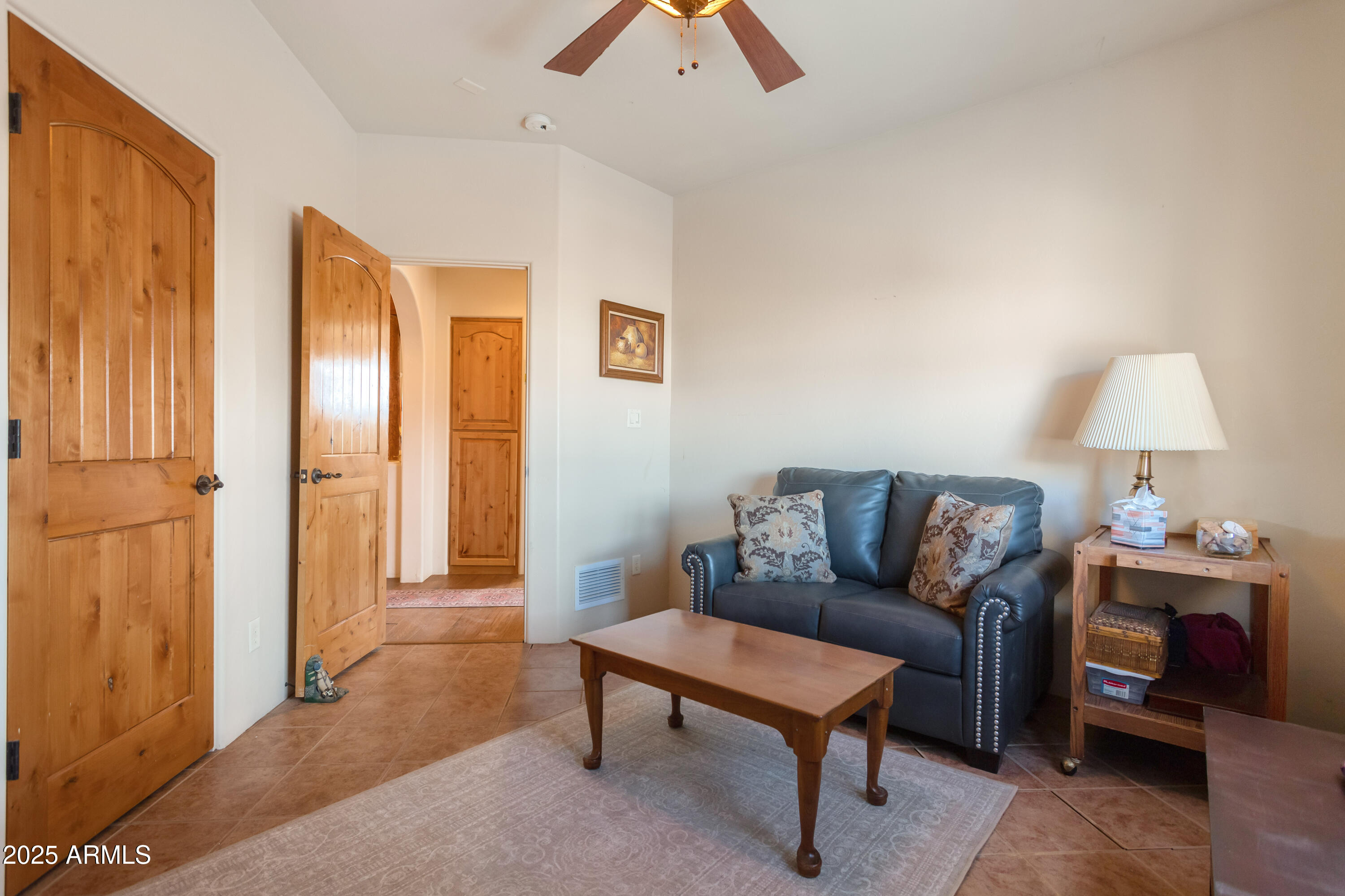 8765 South Airstrip Road Hereford, AZ 85615 - Photo 25 of 47 a living room with furniture and a lamp