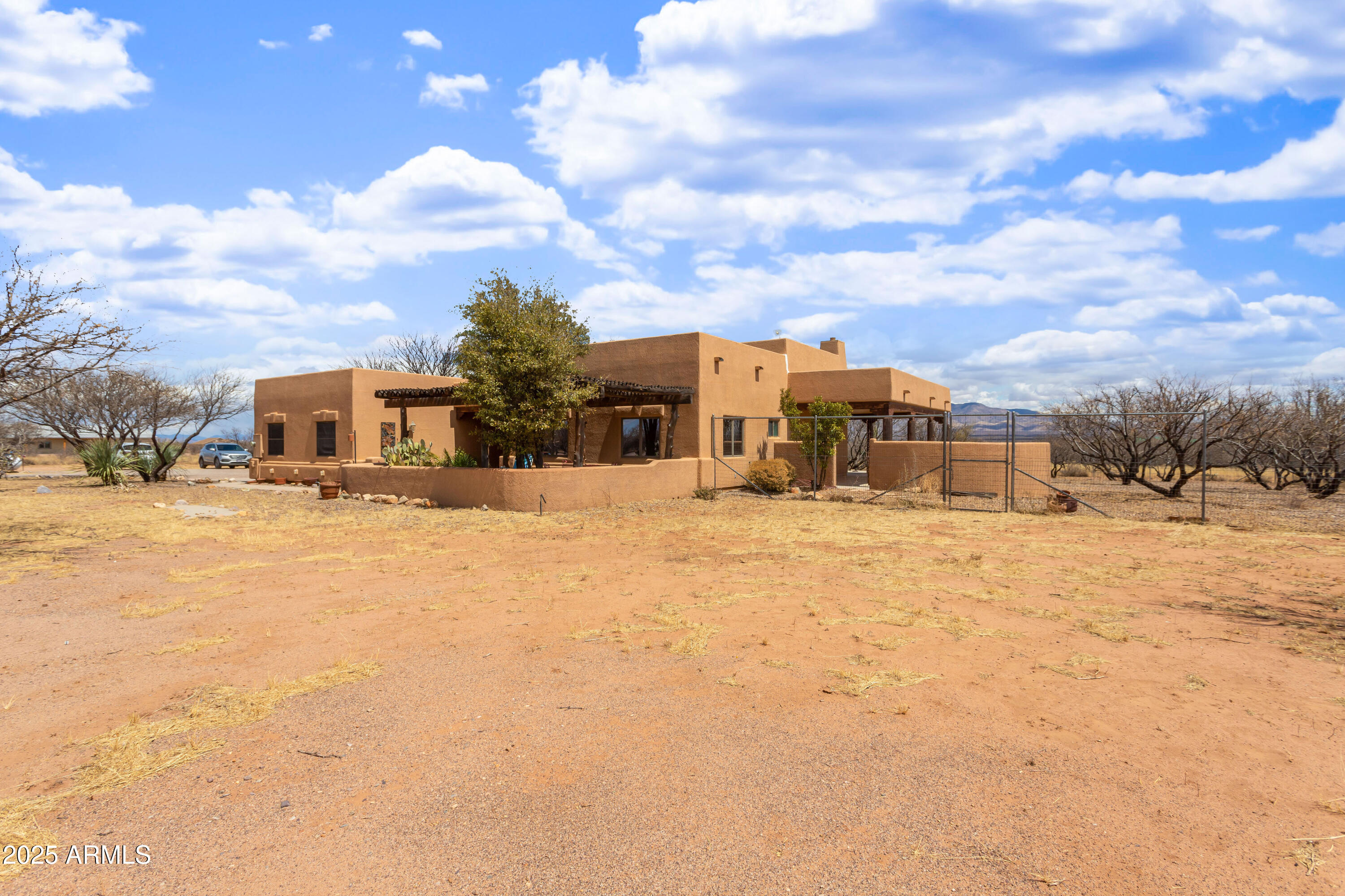 8765 South Airstrip Road Hereford, AZ 85615 - Photo 33 of 47 a front view of a house with a yard