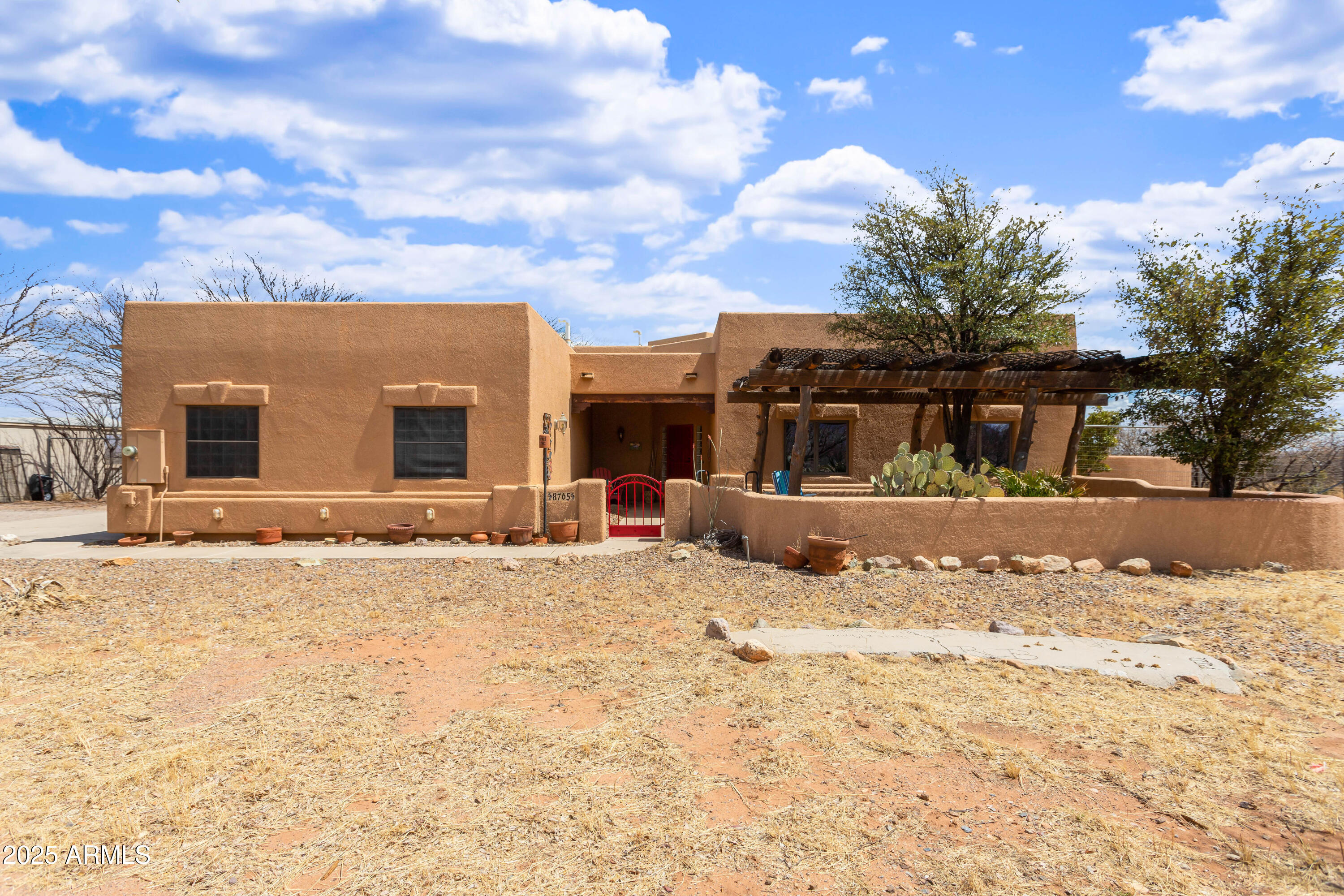 8765 South Airstrip Road Hereford, AZ 85615 - Photo 6 of 47 a front view of a house with a yard