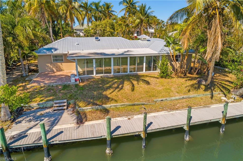 2195 Sheepshead Drive Naples, FL 34102 - Photo 3 of 14 a view of a house with swimming pool and sitting area