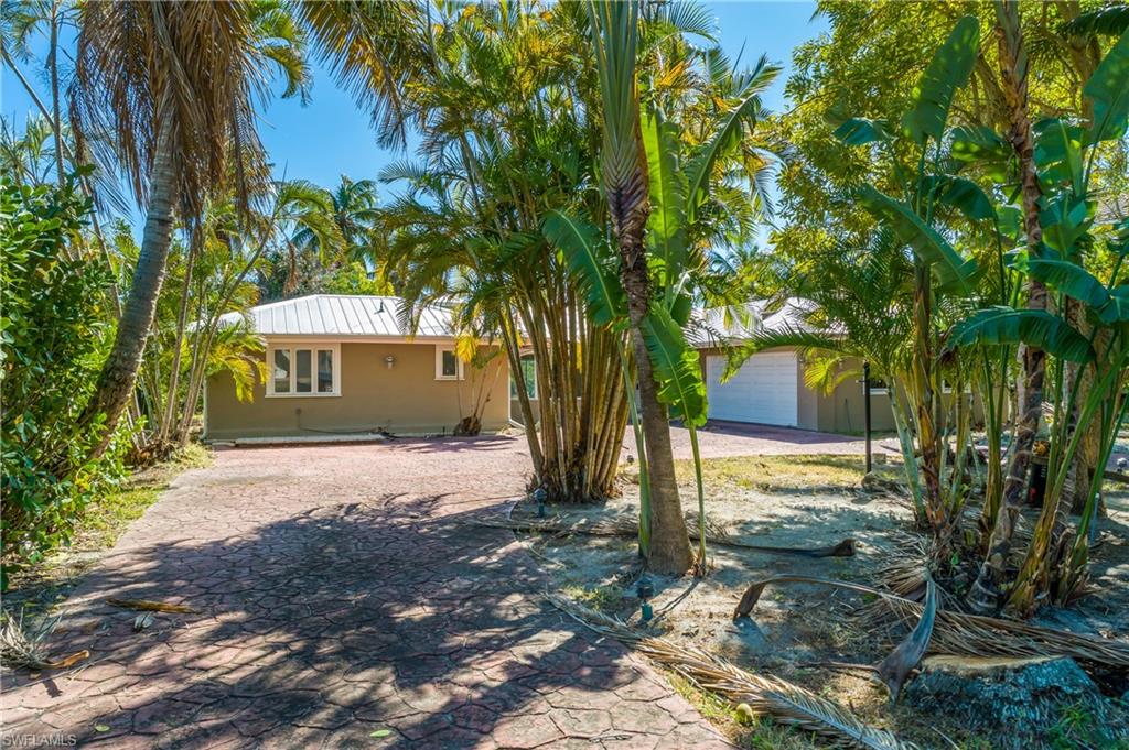 2195 Sheepshead Drive Naples, FL 34102 - Photo 10 of 14 a front view of a house with a yard and tree