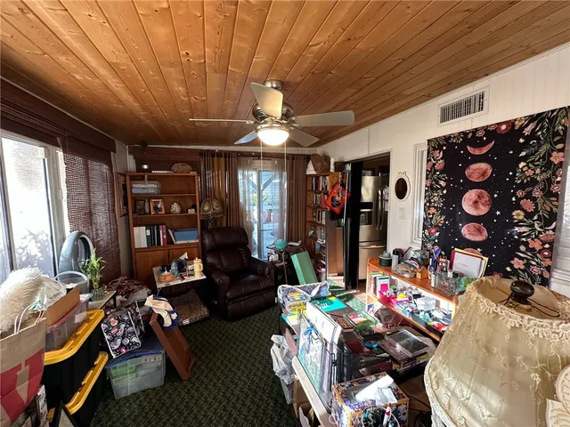 a living room with lots of furniture and clothes