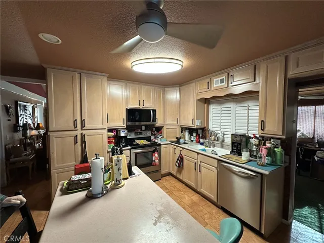 a kitchen with lots of counter top space appliances and cabinets
