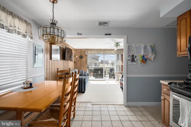 a kitchen with stainless steel appliances granite countertop a stove top oven a sink dishwasher and a refrigerator