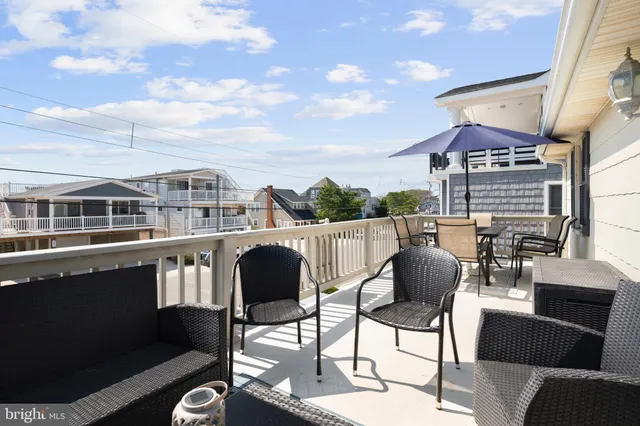 a view of a chairs and table in the balcony