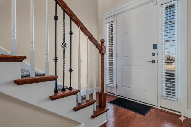 a view of an entryway with wooden floor