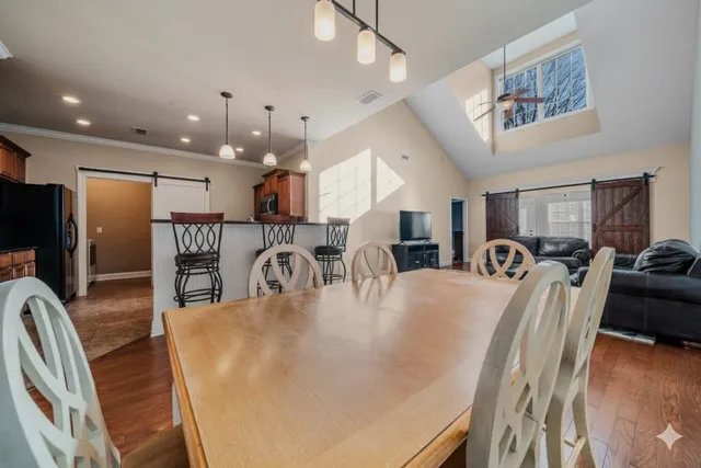 a large kitchen with a table and chairs