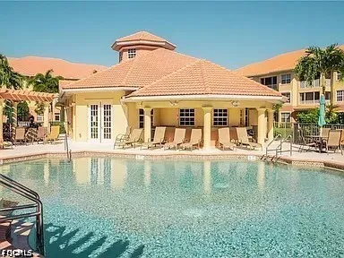 a view of a swimming pool with outdoor seating