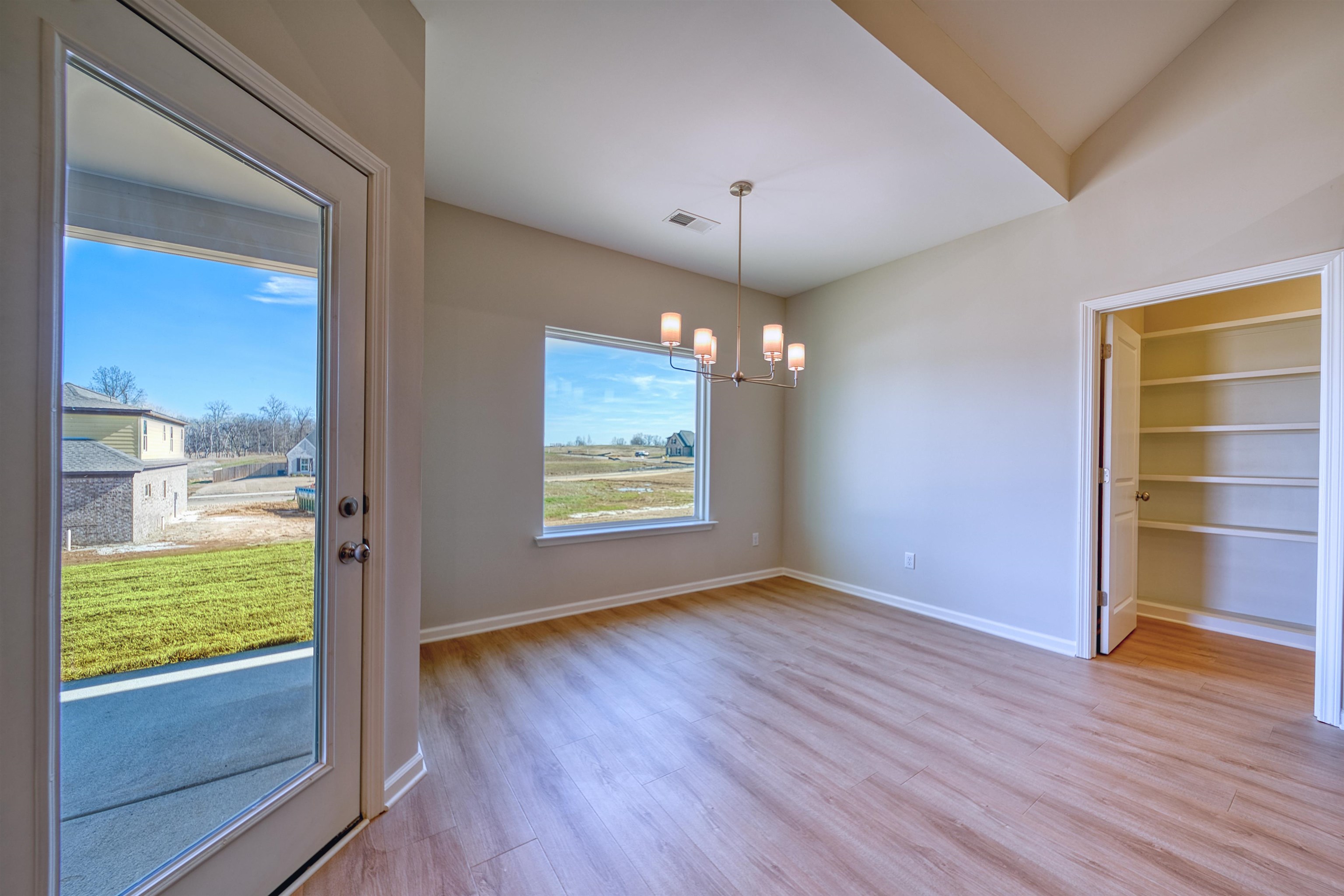 196 Como Lane Atoka, TN 38004 - Photo 15 of 40 wooden floor in an empty room with a window