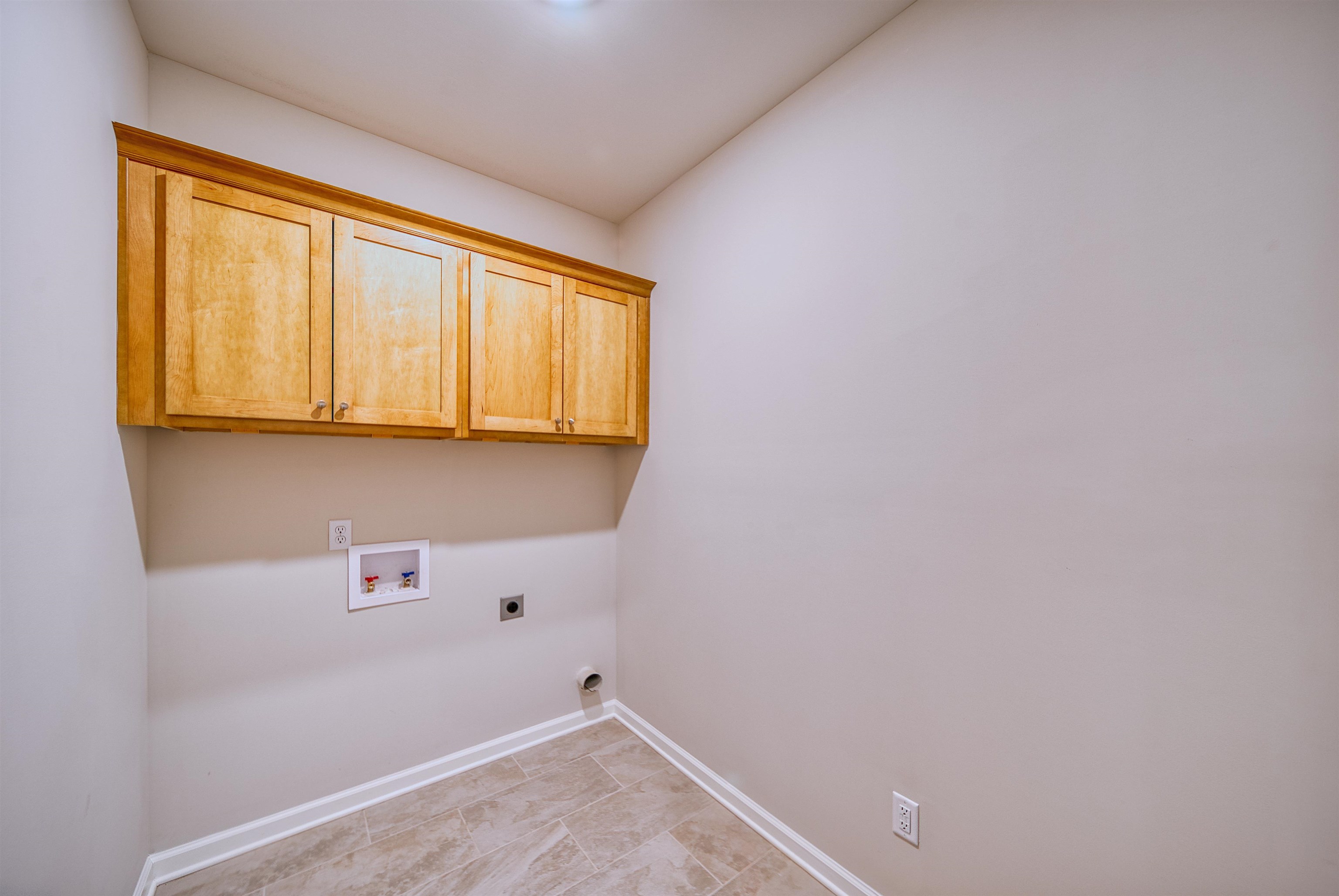 196 Como Lane Atoka, TN 38004 - Photo 18 of 40 Laundry room featuring washer hookup, electric dryer hookup, and cabinet space