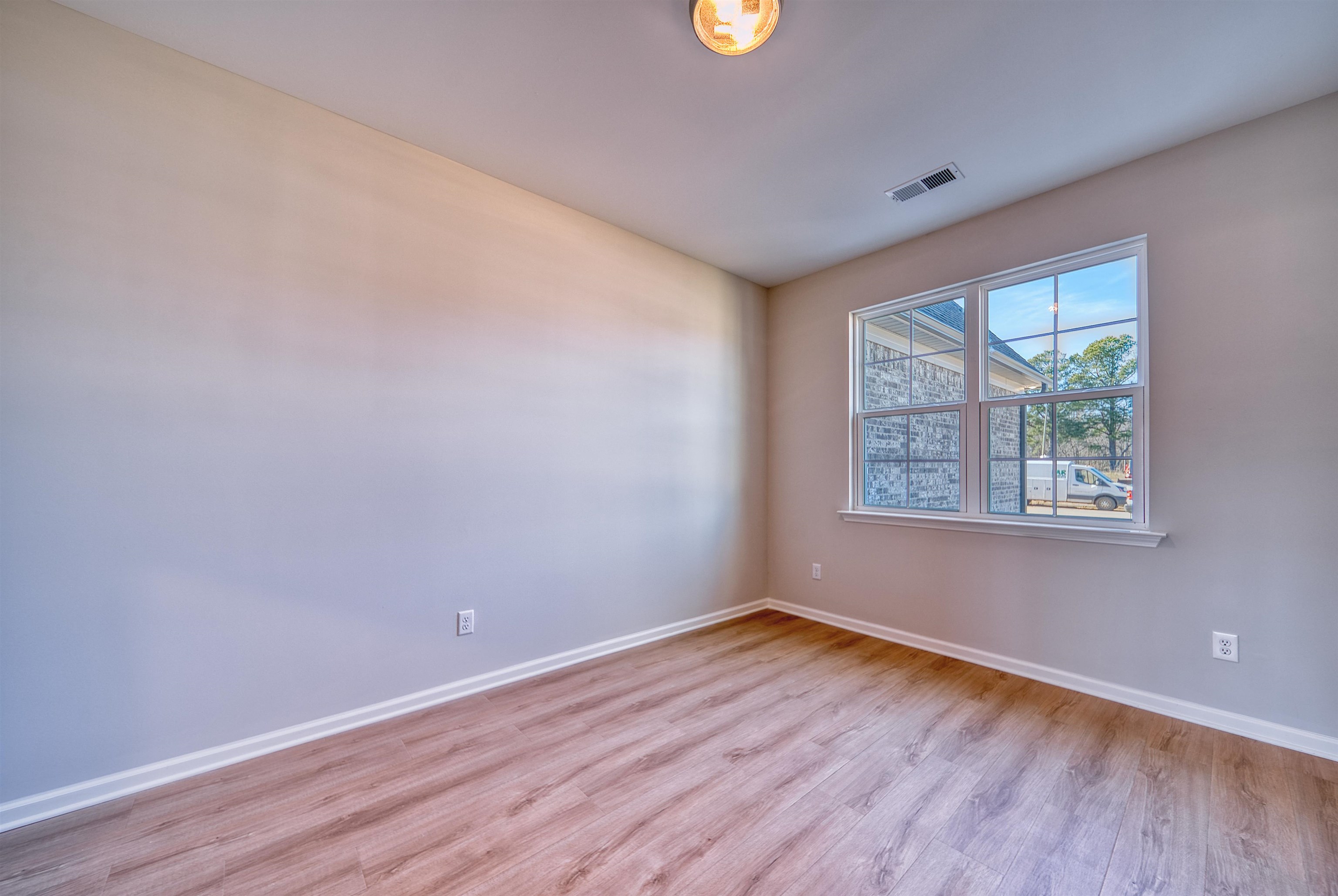 196 Como Lane Atoka, TN 38004 - Photo 21 of 40 an empty room with wooden floor and windows