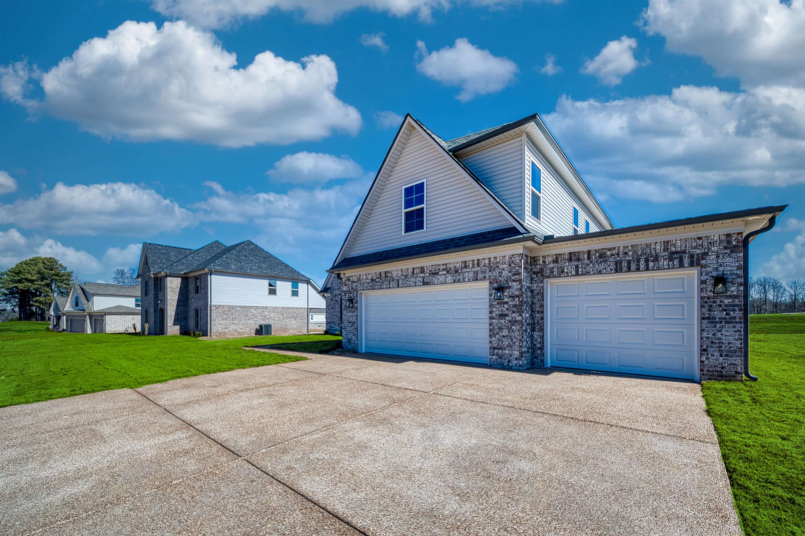 196 Como Lane Atoka, TN 38004 - Photo 30 of 40 a front view of a house with a yard and garage