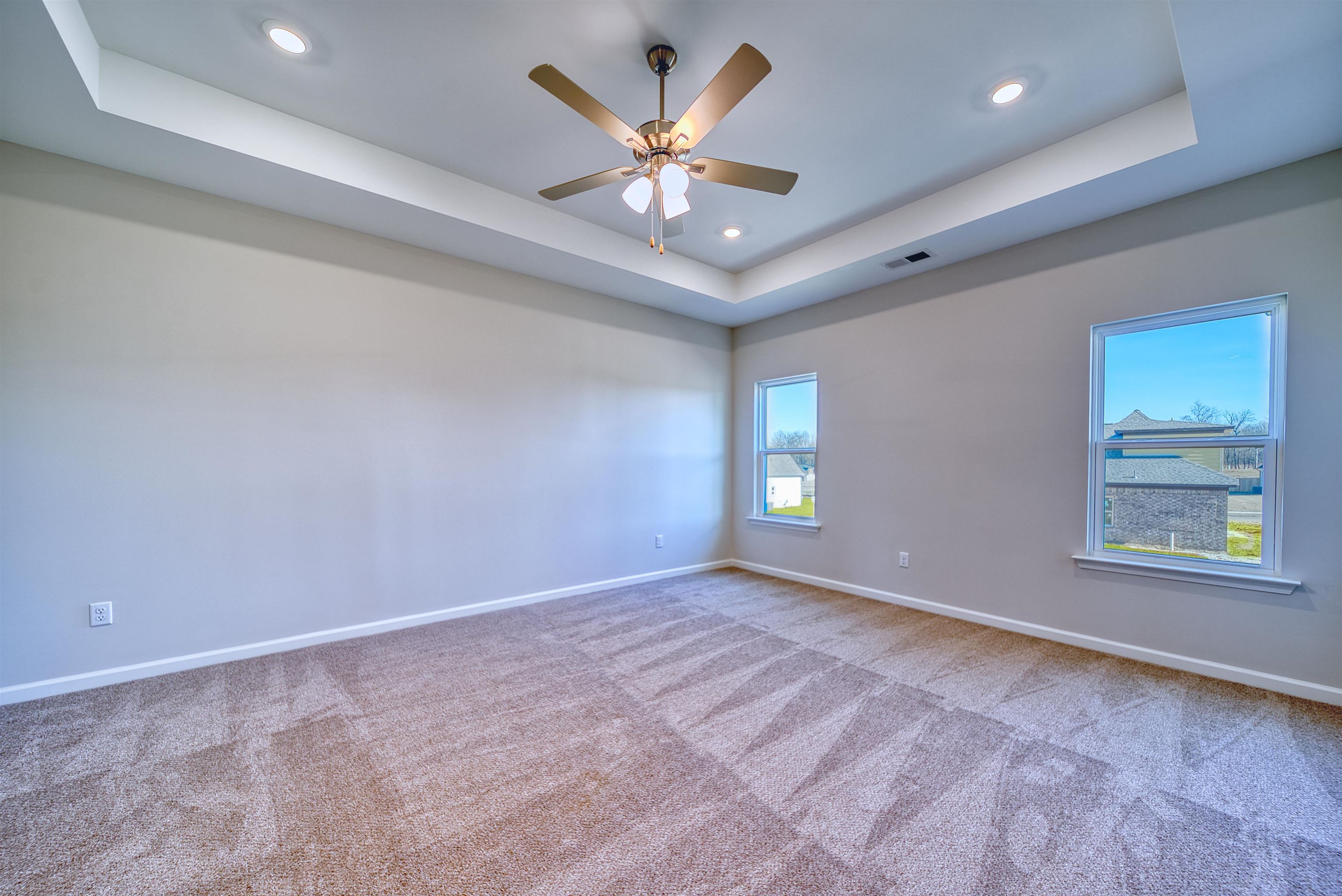 196 Como Lane Atoka, TN 38004 - Photo 7 of 40 Unfurnished room featuring a raised ceiling, ceiling fan, recessed lighting, and light colored carpet