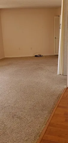 a view of an empty room and a window