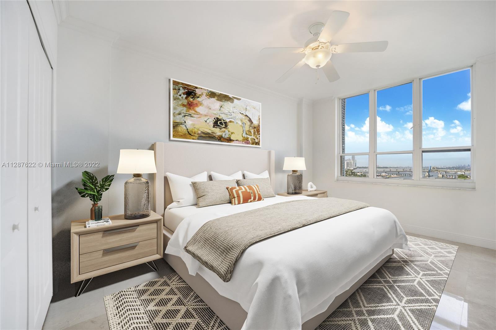 888 Brickell Key Drive, Unit 1508 Miami, FL 33131 - Photo 4 of 12 a bedroom with a large bed and a window