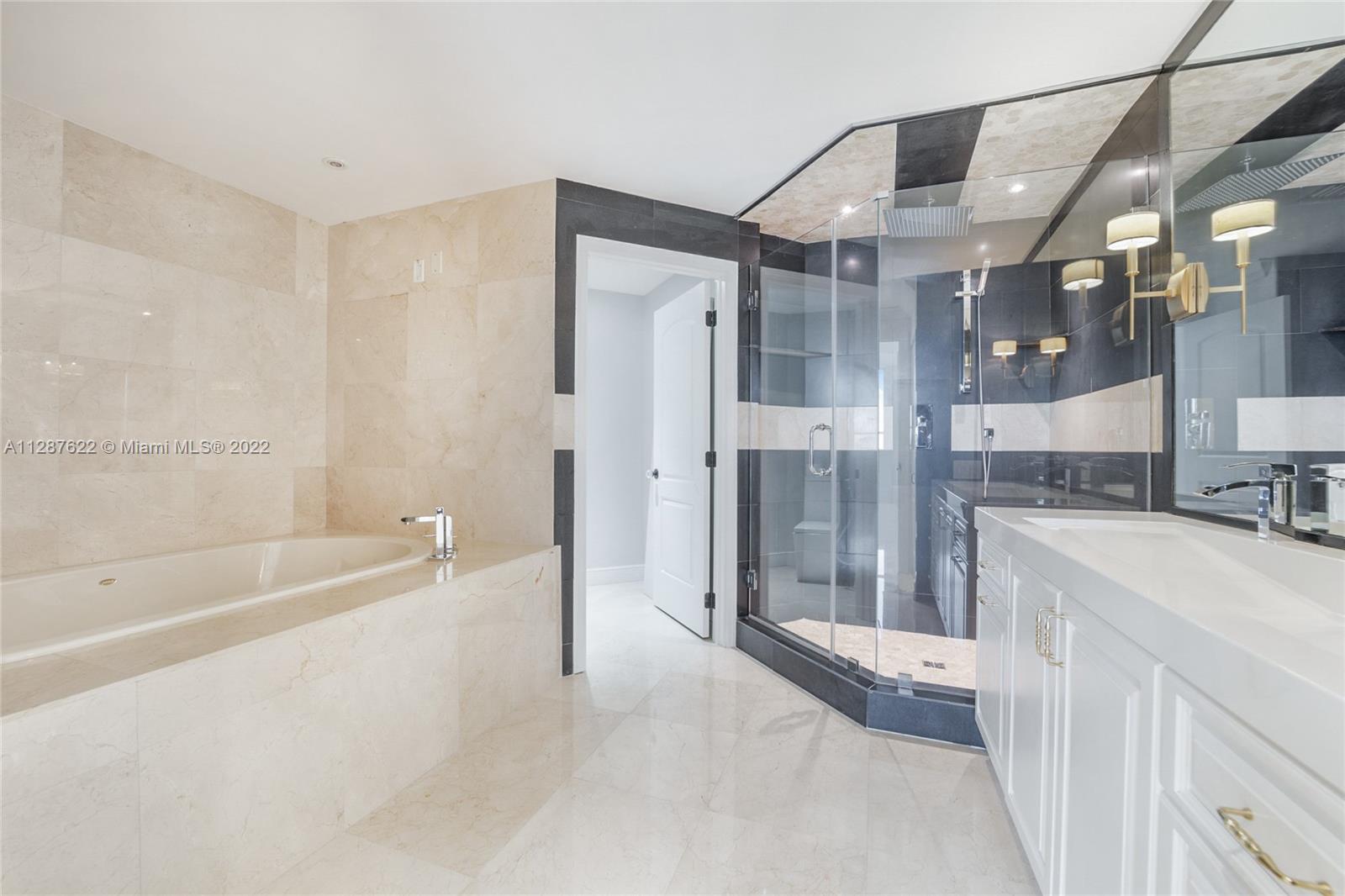 888 Brickell Key Drive, Unit 1508 Miami, FL 33131 - Photo 6 of 12 a bathroom with a bathtub and a shower