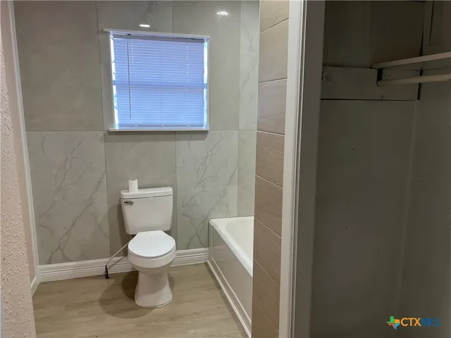 a white toilet sitting next to a sink