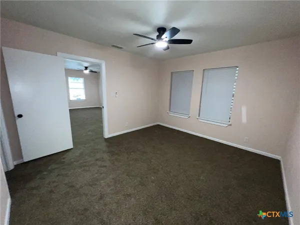 an empty room with a empty space and windows