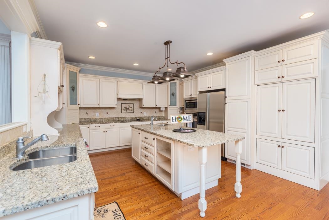 1068 Entry School Road Fishersville, VA 22939 - Photo 28 of 74 a kitchen with kitchen island granite countertop a sink cabinets and stainless steel appliances