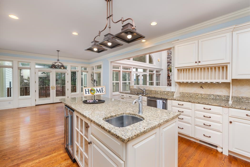 1068 Entry School Road Fishersville, VA 22939 - Photo 31 of 74 a kitchen with stainless steel appliances granite countertop a sink a stove and a wooden floors