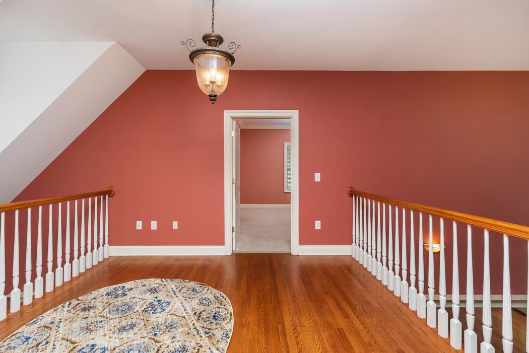 1068 Entry School Road Fishersville, VA 22939 - Photo 51 of 74 a view of a hallway with wooden floor and a chandelier