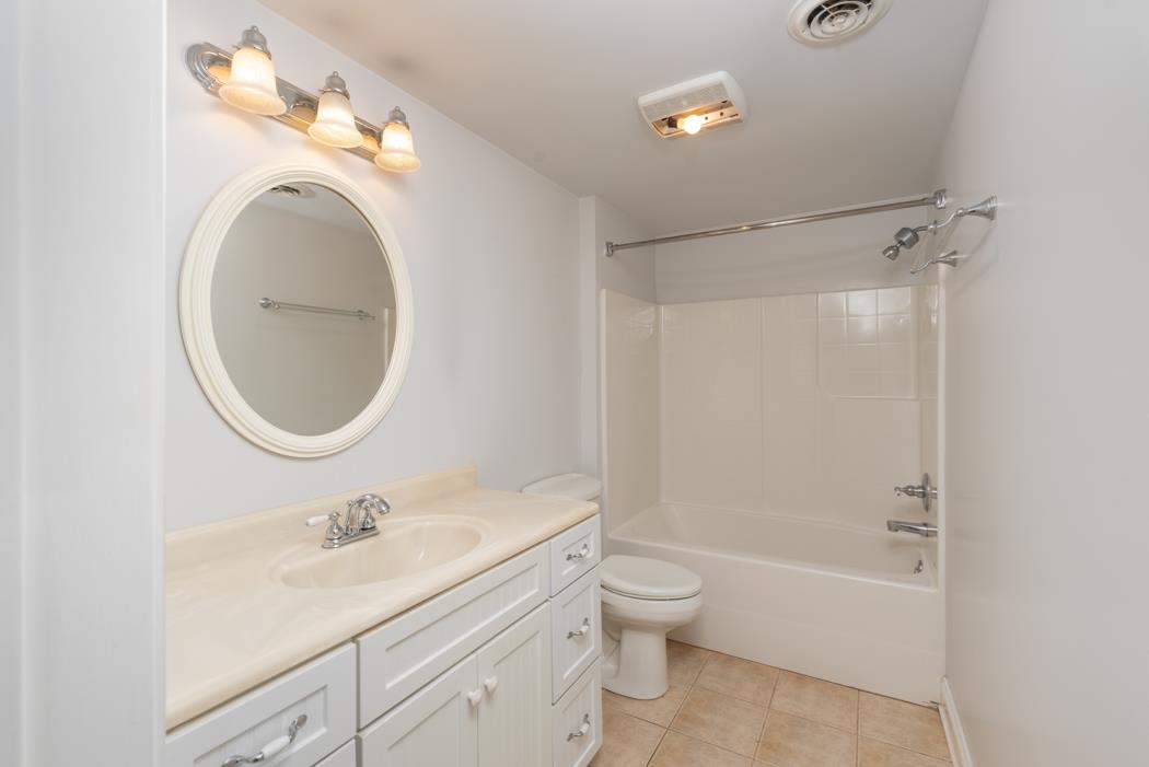 1068 Entry School Road Fishersville, VA 22939 - Photo 57 of 74 a bathroom with a toilet a sink a mirror and bathtub
