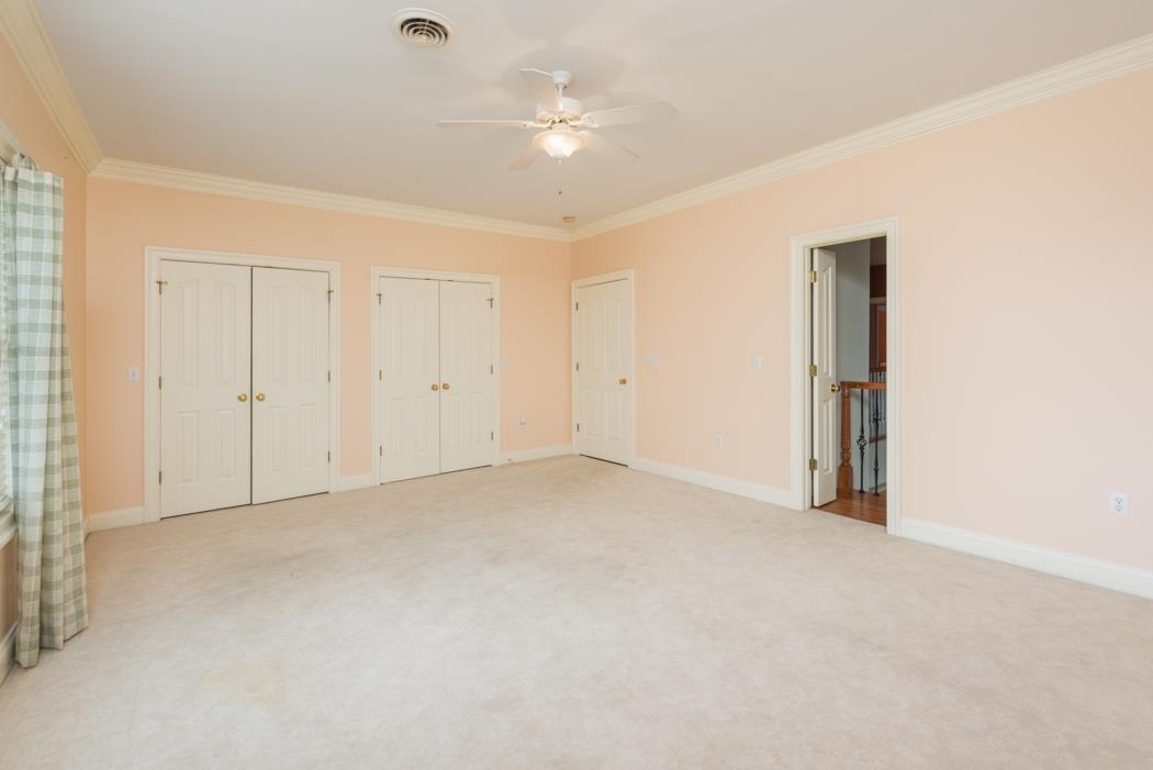 1068 Entry School Road Fishersville, VA 22939 - Photo 59 of 74 an empty room with a ceiling fan and a window