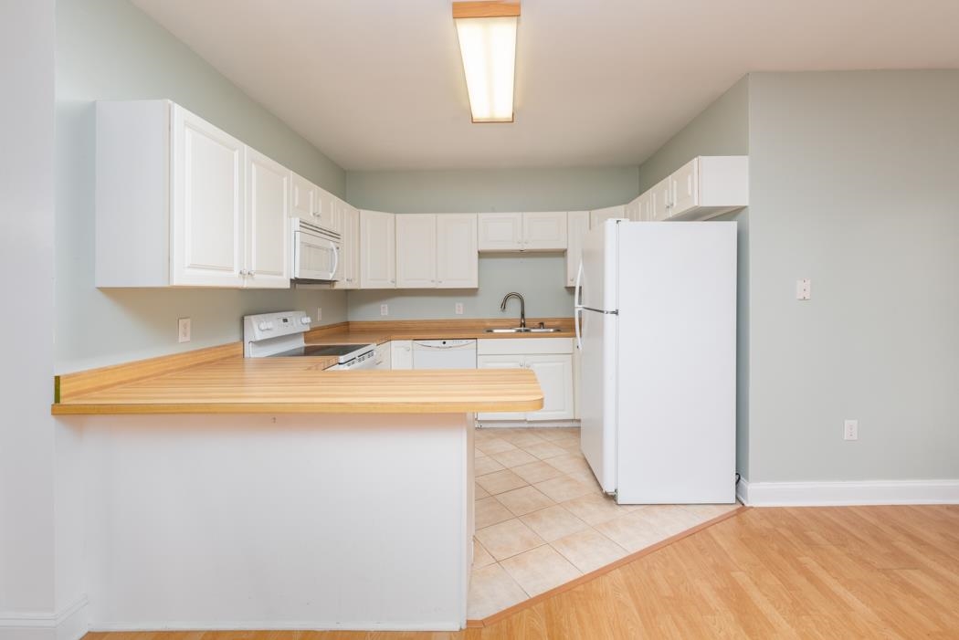 1068 Entry School Road Fishersville, VA 22939 - Photo 61 of 74 a kitchen with stainless steel appliances granite countertop a sink and a refrigerator
