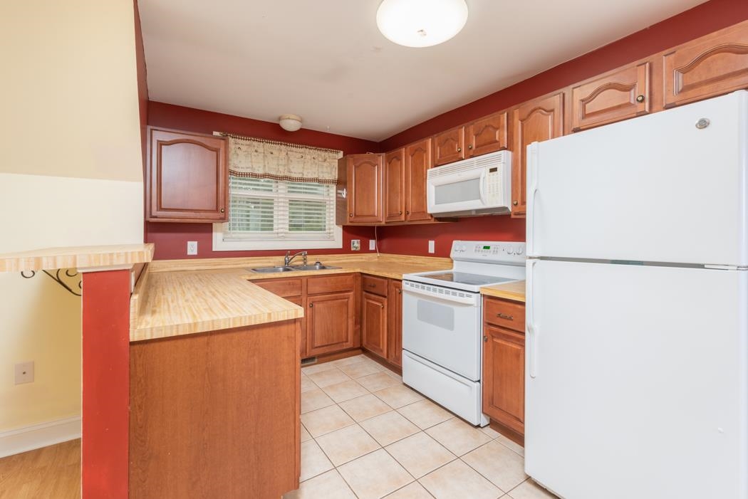 1068 Entry School Road Fishersville, VA 22939 - Photo 70 of 74 a kitchen that has a sink and a refrigerator