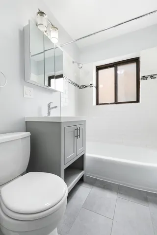 a bathroom with a toilet a sink and bathtub