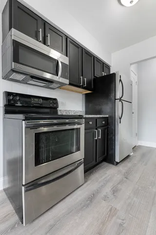 a kitchen with stainless steel appliances and cabinets