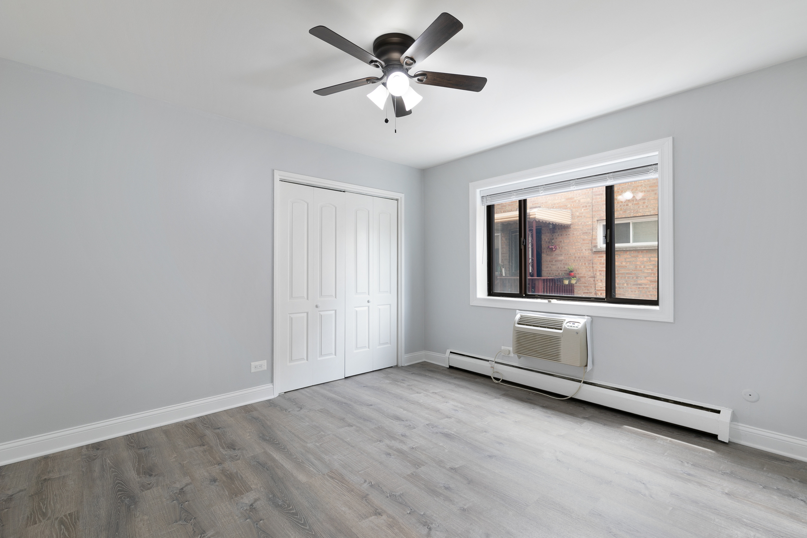 6826 North Ridge Boulevard, Unit 404 Chicago, IL 60645 - Photo 10 of 17 an empty room with windows and fan