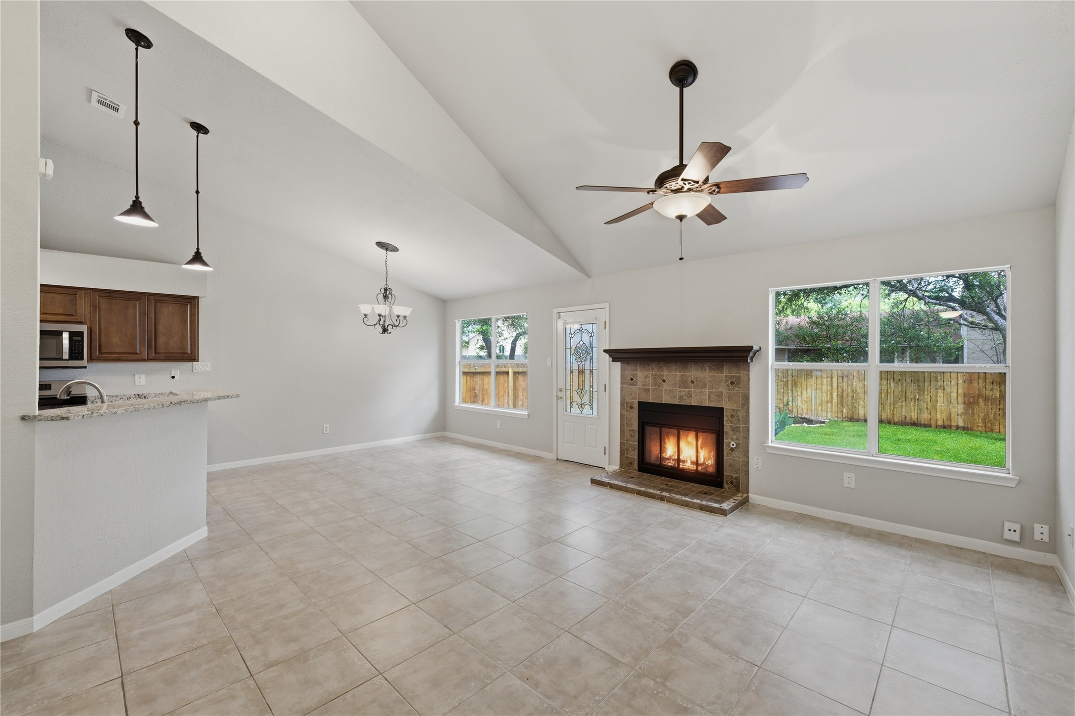 1317 Mimosa Pass Cedar Park, TX 78613 - Photo 9 of 20 a view of an empty room with a fireplace and a window