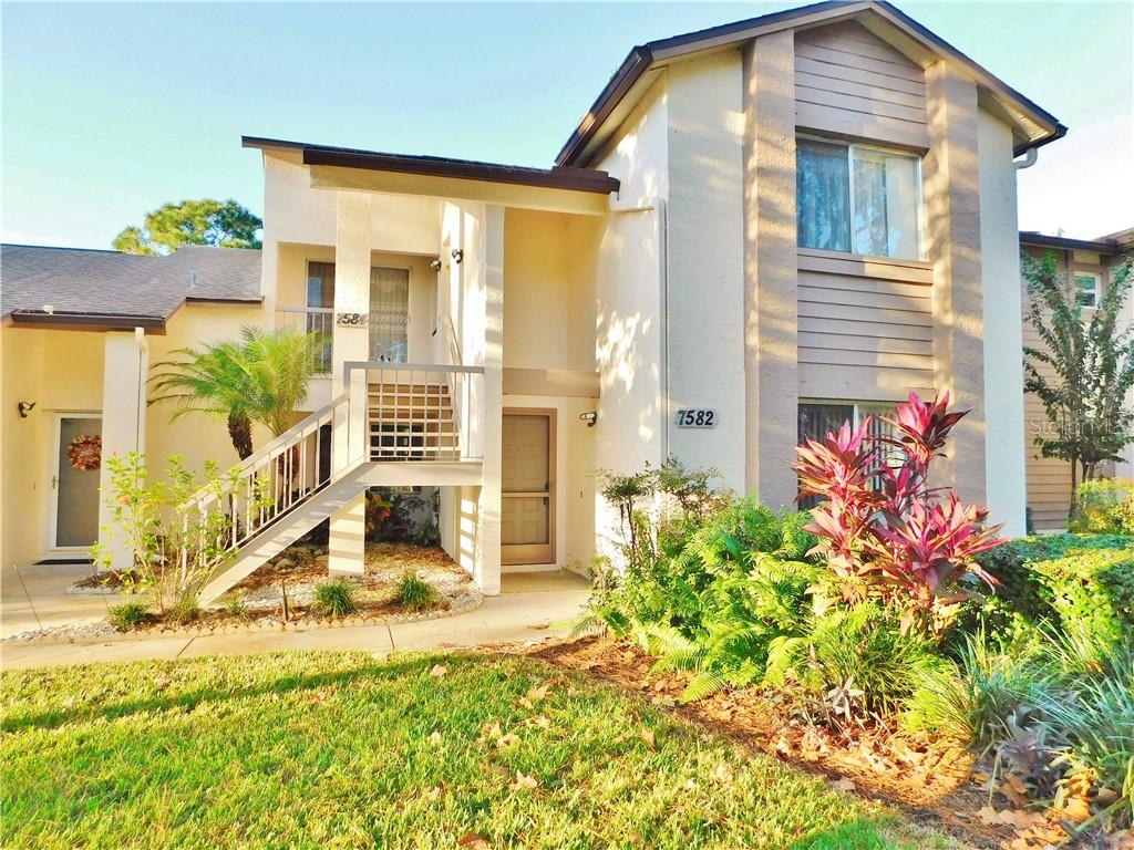 7582 St Andrews Boulevard Weeki Wachee, FL 34613 - Photo 1 of 1 a front view of a house with a yard