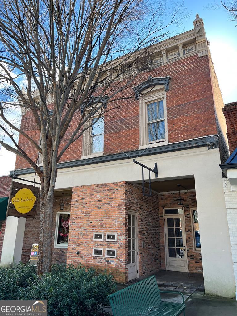 a front view of a building with a garden