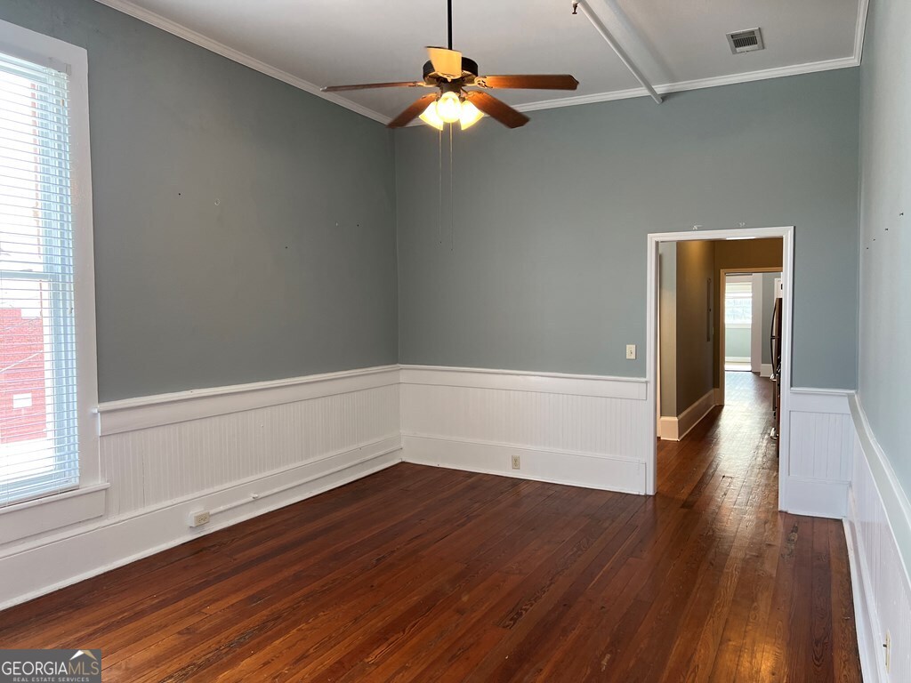 128 West Jackson Street, Unit E Dublin, GA 31021 - Photo 2 of 6 a view of an empty room with wooden floor