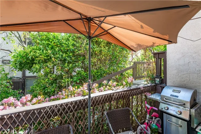 a view of a chairs and table in the backyard