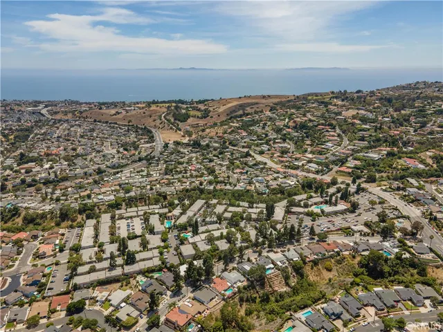 a view of street along with house and trees