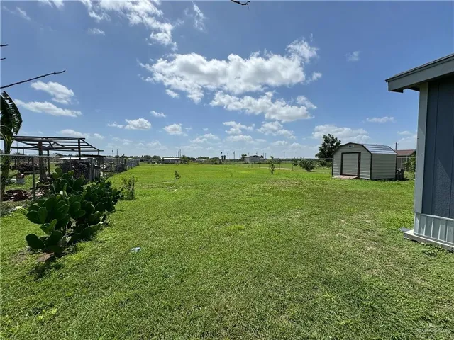 a house view with swimming pool and garden space
