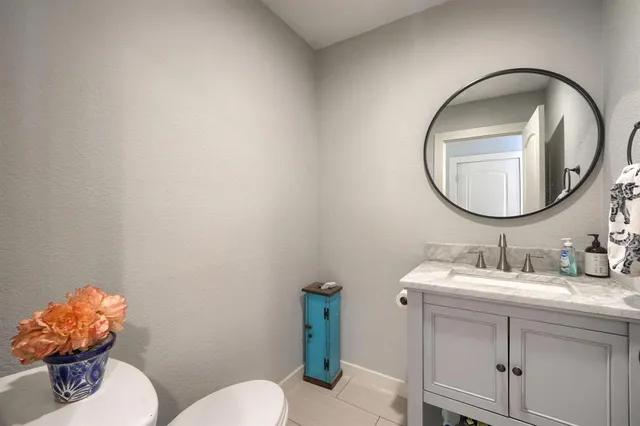 a bathroom with a sink mirror and toilet