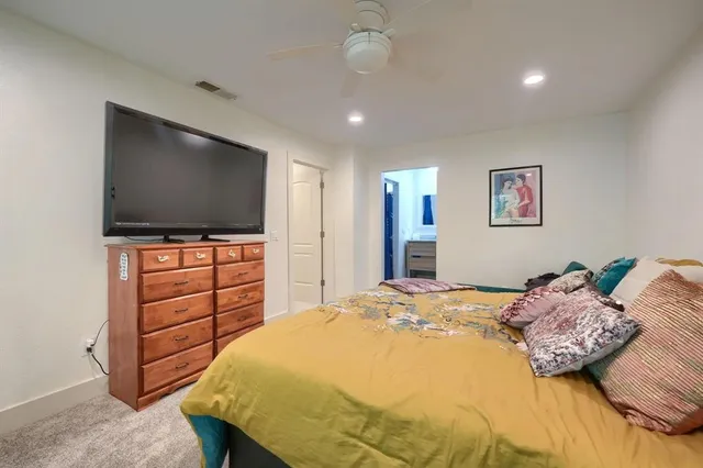 a bedroom with a bed and a flat screen tv