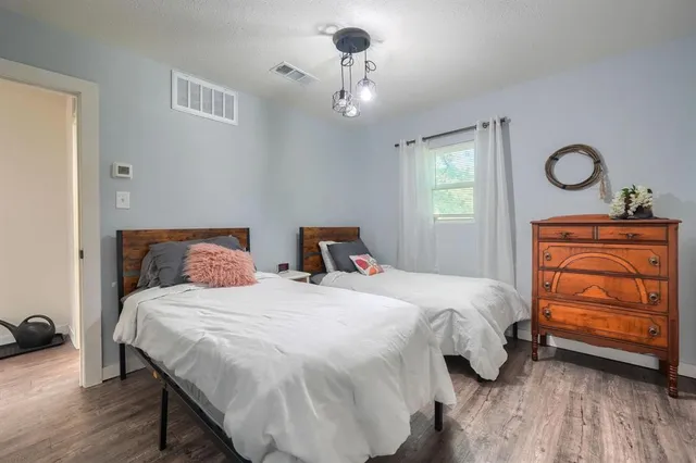 a bedroom with a bed and a chandelier